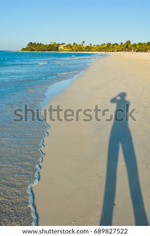 Shadow of tourist taking pictures in Varadero, Cuba