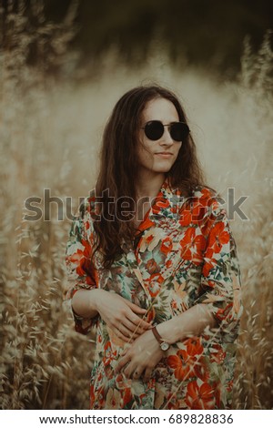 Pretty young fashion woman with sunglasses.  Vintage portrait young woman walking in park. Close up portrait of a woman with sunglasses