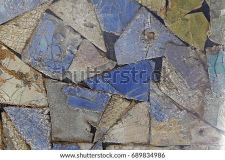Colorful old stone mosaic on the wall. Detail of beautiful old collapsing abstract ceramic mosaic adorned building. Venetian mosaic as decorative background. Selective focus. Abstract Pattern. 