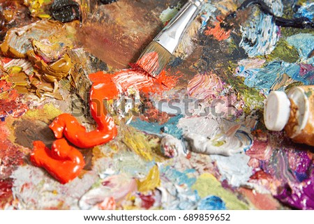 Canvas with paint and brushes for artists and oil paint for artists. Background and texture are large.