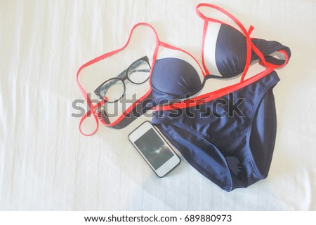 Swimsuit set on the floor with a sea-view concept.