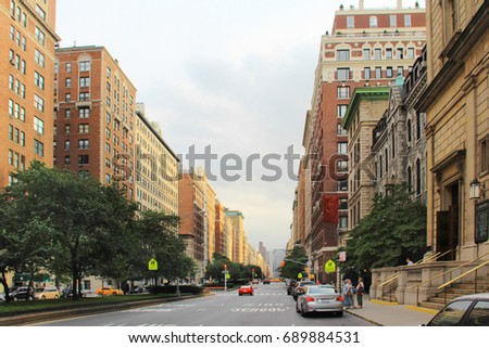 City: Wide Street with Traffic Island and Trees. School Zone with Brick Buildings in One-point Perspective.