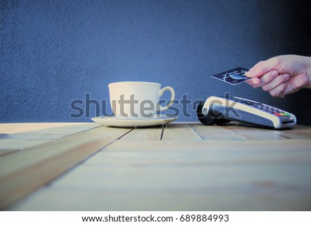 contactless payment card pdq background copy space with hand holding credit card ready to pay at cafe for coffee stock, photo, photograph, picture, image