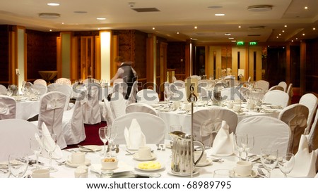 Hotel Hall interior with  round tables set up for dinner