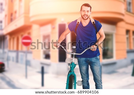 Full length of young man with bicycle against entrance of cafe