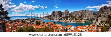 Panoramic view of the Omis on Adriatic sea surrounded by high mountains with amazing canyon of river Cetina, Dalmatia, Croatia. Royalty-Free Stock Photo #689915128