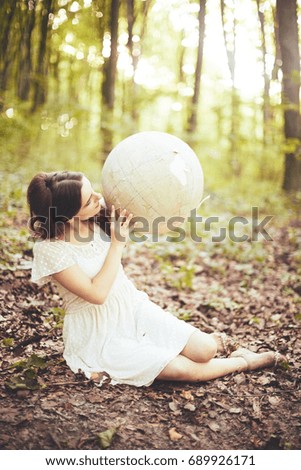 Beautiful girl with a globe