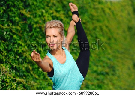 Closeup picture of a woman practicing king dancer yoga pose