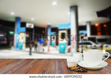 A cup of coffee on the wooden table at coffee shop in the gas station Royalty-Free Stock Photo #689939032