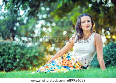 Beautiful woman sitting on the grass
