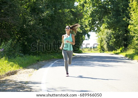 Athletic happy brunette woman working out in a meadow, from a complete series of photos