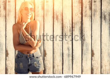 Smiling girl with bikini against wood background
