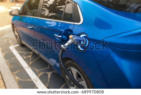 Electric Vehicle Charging Royalty-Free Stock Photo #689970808