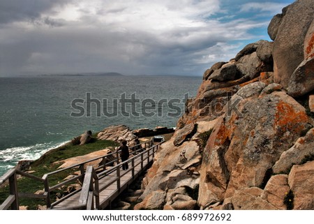Access to the cliffs of Ccap Prioriño, Ferrol, A Coruña, Galicia, Spain,composition of wooden stairs in a surreal  landscape by the ocean, psychological photography, abstract surrealism,  