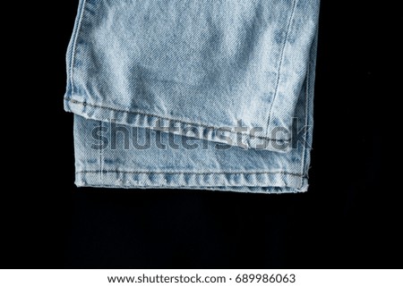 Blue jeans on black background. Vintage Denim. Grunge wallpaper