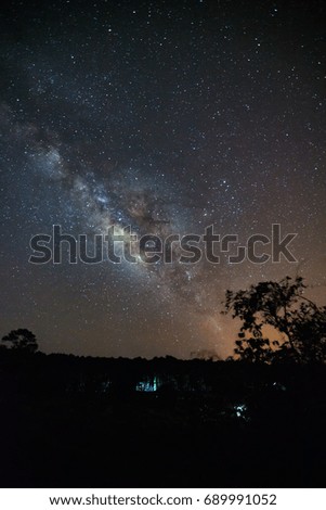 milky way galaxy and silhouette of tree with cloud at Phu Hin Rong Kla National Park,Phitsanulok Thailand