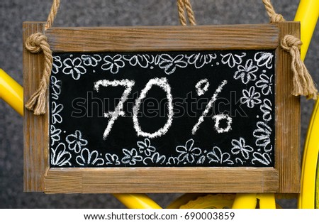 wooden board with word 70 percent written with chalk, signboard. symbol of information, business, marketing and  selling
