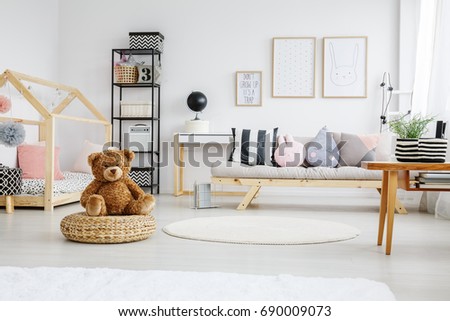 Fun white stylish playroom of girl with poster on wall