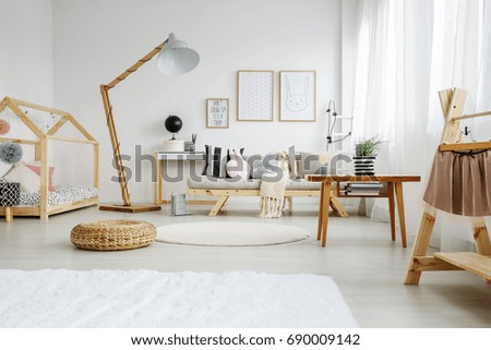 Stylish scandinavian fun bedroom of girl with decorative pillows
