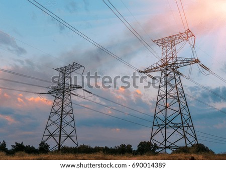 high voltage electric power steel tower in the setting sun, closeup of photo.