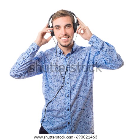 Smiling young man listening to music with headphones isolated on white background