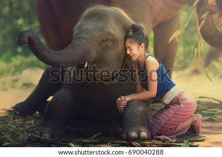 The young lady is sitting together with her best friend elephant.