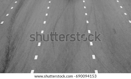 white paint line on black asphalt. space transportation background