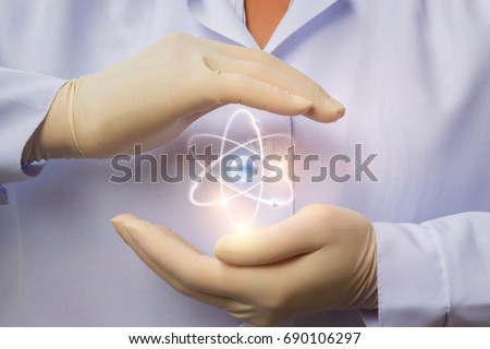 Protection of peaceful nuclear energy in the hands of the scientist. Royalty-Free Stock Photo #690106297