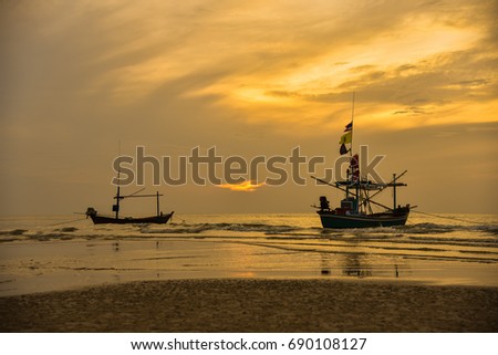 Beautiful early morning sunrise, fishing boat on the seaside, beauty of white waves on the sea.