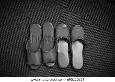 Slipper shoes in the hotel room. This image was blurred or selective focus. Black and white picture. 