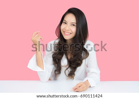 beauty woman smile and look you happily with isolated pink background, asian