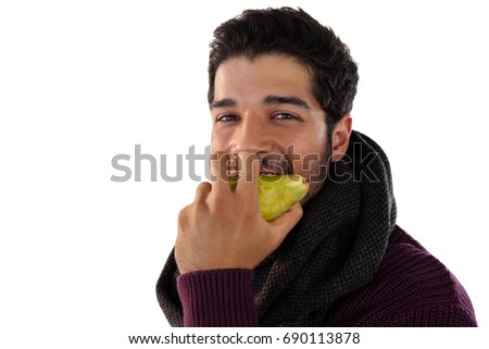 Portrait of smiling man eating pears against white background
