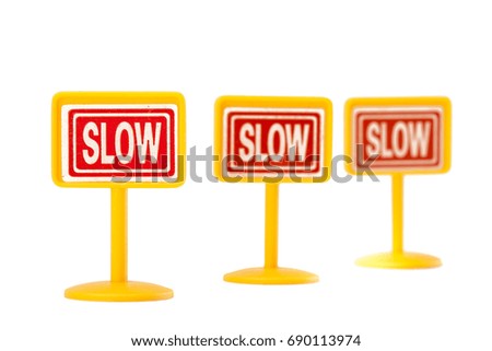 Plastic toy slow sign isolated on white background
