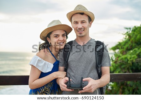 Smiling couple  take selfie with drone. Happy young couple on vacation
