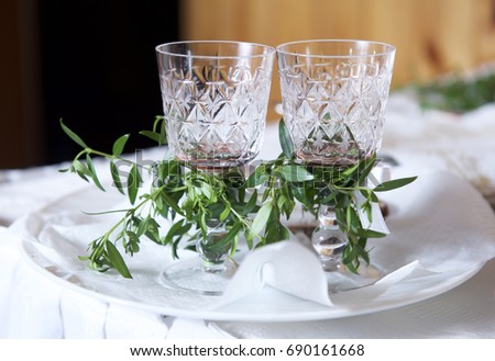 Two small glasses decorated with rue flower in wedding. Ruta graveolens, commonly known as rue, is a species of Ruta grown as an ornamental plant and herb. Wedding traditions in Lithuania