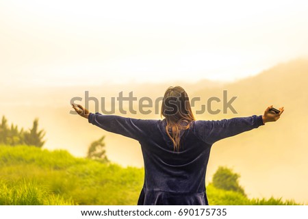 a women get the sunshine, she has a refreshing feeling Royalty-Free Stock Photo #690175735