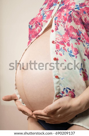 Image of pregnant woman touching her big belly. Close up. Motherhood, pregnancy, people and expectation concept. Pregnant woman expecting baby