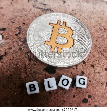 Digital currency physical metal bitcoin coin with white square letters sign blog.