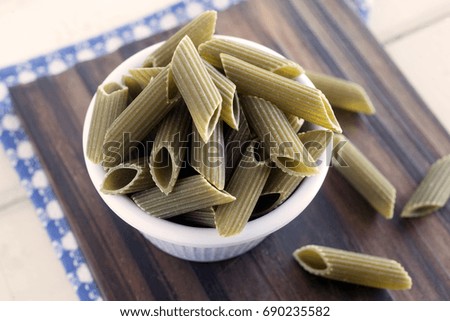 Dry spinach penne rigate pasta.