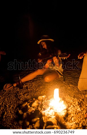 Party friends around the fire