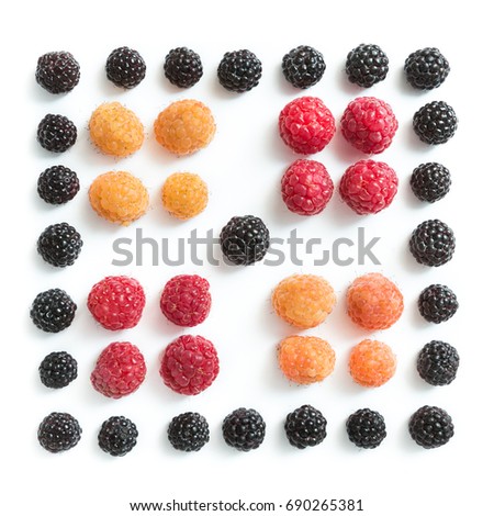 A symmetrical square lined with blackberries, red and yellow raspberries on white isolated background