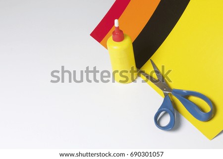 School accessories for creativity. Color paper, glue and scissors for applique. On a white background.