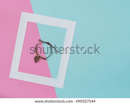Empty frame and label flat lay on blue and pink pastel background with copy space. Soft effect filter. Minimal concept.