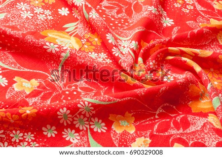 Texture, background, pattern. Cotton cloth of red color, On the fabric are painted flowers yellow white
