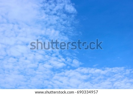 Blue sky with scattered clouds moving with the wind

