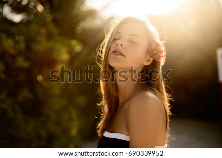 Spa wellness beach beauty woman relaxing and sun bathing on beach. Beautiful serene and peaceful young female model on holiday travel resort enjoting vacation. Sun protection concept Royalty-Free Stock Photo #690339952