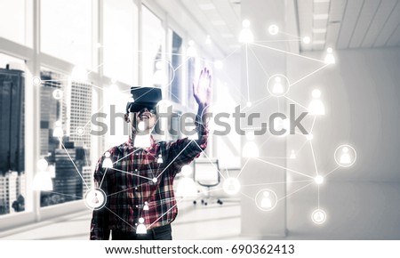 Young man with virtual reality headset or 3d glasses over social connection background . Mixed media