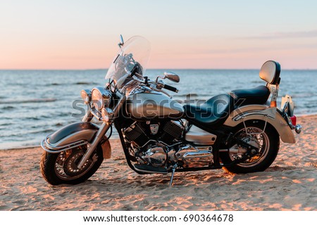 Motorcycle chopper on the beach Royalty-Free Stock Photo #690364678