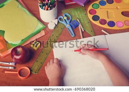 Kids hands drawing on notebook