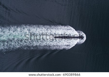 Overhead view of a Nato submarine at sea sailing above the surface. Shot with a drone from straight above it  Royalty-Free Stock Photo #690389866